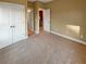 Spacious bedroom with double doors and neutral carpeting at 4330 Balsam Bark Dr, Cumming, GA 30028