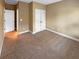 Empty carpeted bedroom with double doors at 4330 Balsam Bark Dr, Cumming, GA 30028