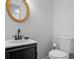 Updated half bathroom with a stylish vanity and gold-framed mirror at 3798 Valley Brook Rd, Snellville, GA 30039