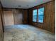 Spacious living room with wood paneling and large windows at 4414 Blackbirch Ln, Decatur, GA 30034