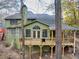 Two story green house with deck and wooded lot at 3830 High Point Cir, Cumming, GA 30041