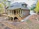 Green house with deck and stone pathway, wooded setting at 3830 High Point Cir, Cumming, GA 30041