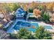 Community pool and clubhouse with surrounding fall foliage at 3830 High Point Cir, Cumming, GA 30041