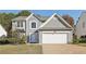 Two-story house with gray siding, white garage door, and landscaping at 2715 Chelwick Sw Dr, Marietta, GA 30008