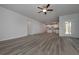 Living area with wood-look flooring, a ceiling fan, and open view to the kitchen at 5981 Northbend Ct, Douglasville, GA 30134