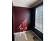 Small bedroom with burgundy walls and window at 1056 Brandon Hill Way, Jonesboro, GA 30238