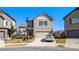 Two-story house with beige siding, attached garage, and a well-manicured lawn at 2291 Elise Way, Hampton, GA 30228
