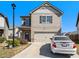 Two-story house with beige siding, attached garage, and a car parked in the driveway at 2291 Elise Way, Hampton, GA 30228