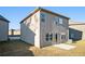 Rear view of house with patio, AC unit, and yard at 2291 Elise Way, Hampton, GA 30228
