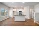 Modern kitchen with white cabinets, granite countertops and a kitchen island at 2291 Elise Way, Hampton, GA 30228