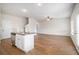 Modern kitchen with white cabinets, granite countertops, and a kitchen island at 2291 Elise Way, Hampton, GA 30228