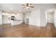 Open concept living room and kitchen with hardwood floors and a ceiling fan at 2291 Elise Way, Hampton, GA 30228