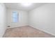 Well-lit bedroom with carpet and neutral walls at 4796 Fairforest Dr, Stone Mountain, GA 30088