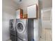 Laundry room with washer, dryer and cabinets at 6079 Braidwood Nw Bnd, Acworth, GA 30101