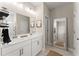 Double vanity bathroom with white cabinets and a large mirror at 510 Cooper Ln, Woodstock, GA 30189