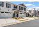 Two-story townhome with white and gray brick exterior, two-car garage, and landscaped front yard at 510 Cooper Ln, Woodstock, GA 30189