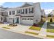 Two-story townhome with white and gray brick exterior, two-car garage, and landscaped front yard at 510 Cooper Ln, Woodstock, GA 30189