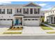 Two-story townhome with white and gray brick exterior, two-car garage, and landscaped front yard at 510 Cooper Ln, Woodstock, GA 30189