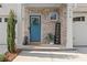 Stylish front door with teal color, welcome sign, and landscaping at 510 Cooper Ln, Woodstock, GA 30189