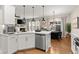 Open kitchen with white cabinets, stainless steel appliances, and island at 510 Cooper Ln, Woodstock, GA 30189