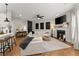 Open living space with sectional sofa, fireplace, and hardwood floors at 510 Cooper Ln, Woodstock, GA 30189
