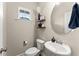 Small powder room with toilet, sink, and decorative accents at 510 Cooper Ln, Woodstock, GA 30189