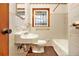 Bathroom with tiled walls, sink, toilet, and bathtub at 2052 Brannen Se Rd, Atlanta, GA 30316