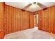 Wood-paneled bedroom with a ceiling fan, carpet, and two doorways at 2052 Brannen Se Rd, Atlanta, GA 30316