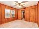 Wood-paneled room with ceiling fan, carpeted floor, and doorway at 2052 Brannen Se Rd, Atlanta, GA 30316