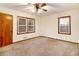 Empty bedroom with carpet, ceiling fan, and two windows at 2052 Brannen Se Rd, Atlanta, GA 30316