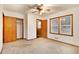 Vacant bedroom featuring carpet, ceiling fan, closet, and bathroom access at 2052 Brannen Se Rd, Atlanta, GA 30316