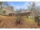 View of brick home's exterior with backyard and surrounding trees at 2052 Brannen Se Rd, Atlanta, GA 30316