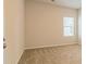Bright bedroom with carpet flooring and large window at 231 Orwell Dr, Social Circle, GA 30025