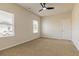 Well-lit bedroom with ceiling fan and two large windows at 231 Orwell Dr, Social Circle, GA 30025