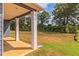 Covered patio with white columns overlooking the backyard at 231 Orwell Dr, Social Circle, GA 30025
