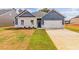 Two-toned house with white brick and blue siding, featuring a white two-car garage at 231 Orwell Dr, Social Circle, GA 30025