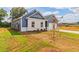 Side view of a two-toned house with landscaping and a partially visible driveway at 231 Orwell Dr, Social Circle, GA 30025