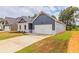 House exterior showcasing a two-car garage and landscaping at 231 Orwell Dr, Social Circle, GA 30025