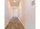 Long hallway with wood-look flooring and neutral walls at 231 Orwell Dr, Social Circle, GA 30025