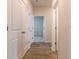 Bright hallway with wood-look flooring and access to bedrooms at 231 Orwell Dr, Social Circle, GA 30025