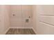 Laundry room with built-in shelving and vinyl flooring at 231 Orwell Dr, Social Circle, GA 30025