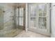 Bathroom with glass shower and window with plantation shutters at 230 Wessex Ct, Atlanta, GA 30328