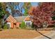 Brick ranch house with a landscaped yard and vibrant fall foliage at 230 Wessex Ct, Atlanta, GA 30328