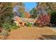 Brick ranch house with a landscaped yard and vibrant fall foliage at 230 Wessex Ct, Atlanta, GA 30328
