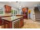 Island kitchen with granite counters, wood cabinets & wine cooler at 230 Wessex Ct, Atlanta, GA 30328