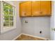 Laundry room with upper cabinets and tile floor at 230 Wessex Ct, Atlanta, GA 30328
