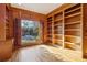 Spacious library with wood paneling, built-in bookshelves, and large window at 230 Wessex Ct, Atlanta, GA 30328