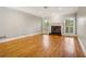 Spacious living room featuring hardwood floors, fireplace, and large windows at 230 Wessex Ct, Atlanta, GA 30328