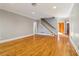Hardwood floors, staircase, and neutral walls grace this open living room at 230 Wessex Ct, Atlanta, GA 30328