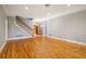 Hardwood floors, staircase, and neutral walls grace this open living room at 230 Wessex Ct, Atlanta, GA 30328